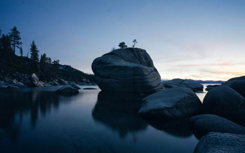 Lake Tahoe rocks on water at sunset